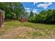 Expansive backyard featuring a red shed, perfect for outdoor activities and storage at 1840 Linwood Ave, Atlanta, GA 30344