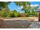Large backyard with a red storage shed, gravel area, and ample green space at 1840 Linwood Ave, Atlanta, GA 30344