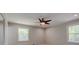 Neutral bedroom has carpeted floors, a ceiling fan, and two bright windows at 1840 Linwood Ave, Atlanta, GA 30344