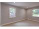 Bedroom with plush carpet and neutral paint has two windows for natural light at 1840 Linwood Ave, Atlanta, GA 30344