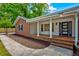 Lovely home with brick and white accents, a brick porch, and a modern front door at 1840 Linwood Ave, Atlanta, GA 30344