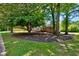 Charming single-story brick house with well-maintained front yard and mature trees at 1840 Linwood Ave, Atlanta, GA 30344
