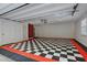 Spacious garage featuring a stylish black and white checkered floor and ample storage space at 1840 Linwood Ave, Atlanta, GA 30344