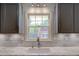 Kitchen featuring white marble countertops, a farmhouse style sink, and gray cabinets at 1840 Linwood Ave, Atlanta, GA 30344