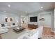 Staged living room with a stylish seating arrangement and an open layout to the dining area at 1840 Linwood Ave, Atlanta, GA 30344