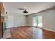 Bright living room with hardwood floors, ceiling fan, and sliding glass doors to the yard at 1840 Linwood Ave, Atlanta, GA 30344