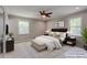 Staged primary bedroom boasts plush carpet, a ceiling fan, and two bright windows at 1840 Linwood Ave, Atlanta, GA 30344