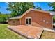 Brick patio with a unique mosaic design, attached to a classic brick home and a well-kept lawn at 1840 Linwood Ave, Atlanta, GA 30344