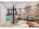 Basement bar with stone wall and stylish seating at 2568 Sugarplum Ne Ct, Atlanta, GA 30345