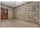 Unique bedroom featuring a stone wall and a ceiling fan at 2568 Sugarplum Ne Ct, Atlanta, GA 30345