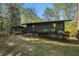 Exterior rear view of home showing wooded scenery and screened porch at 2568 Sugarplum Ne Ct, Atlanta, GA 30345