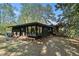 Exterior back view of home showing windows, stone pathway, and wooded scenery at 2568 Sugarplum Ne Ct, Atlanta, GA 30345