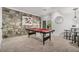 Basement game room with pool table and stone accent wall at 2568 Sugarplum Ne Ct, Atlanta, GA 30345