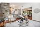 Sunlit living room features a stone accent wall and hardwood floors at 2568 Sugarplum Ne Ct, Atlanta, GA 30345