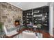 Cozy office with stone fireplace, built-in shelving, and glass top desk at 2568 Sugarplum Ne Ct, Atlanta, GA 30345