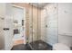 Modern bathroom with glass shower, tile walls, and toilet. Bedroom visible in background at 2568 Sugarplum Ne Ct, Atlanta, GA 30345