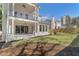 Spacious backyard featuring a large lawn, a patio, and an exterior view of the home's architecture at 52 25Th Nw St, Atlanta, GA 30309