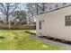 Well-manicured backyard featuring a large lawn, a gravel path, and an exterior view of the home at 52 25Th Nw St, Atlanta, GA 30309
