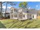 Expansive backyard featuring a large lawn, a patio, and an exterior view of the home at 52 25Th Nw St, Atlanta, GA 30309