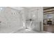 Modern bathroom with marble tile, walk-in shower, gray vanity, and view into bedroom at 52 25Th Nw St, Atlanta, GA 30309