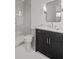 Bathroom features a vanity with a mirror, toilet, and tiled shower at 52 25Th Nw St, Atlanta, GA 30309