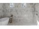 Modern bathroom with marble tile, walk-in shower, and natural light from windows at 52 25Th Nw St, Atlanta, GA 30309
