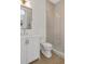 Bathroom featuring a single sink vanity, commode, and glass enclosed shower at 52 25Th Nw St, Atlanta, GA 30309