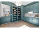 Butler's pantry featuring blue cabinetry, shelving, white countertops, and stylish lighting at 52 25Th Nw St, Atlanta, GA 30309
