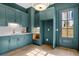 Butler's pantry featuring blue cabinetry, stainless steel fixtures, and recessed lights at 52 25Th Nw St, Atlanta, GA 30309