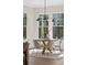 Dining room features a round table, modern lighting, neutral decor, and large windows at 52 25Th Nw St, Atlanta, GA 30309