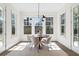 Bright dining room with large windows, round table, modern lighting, and neutral decor at 52 25Th Nw St, Atlanta, GA 30309