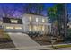 Elegant two-story white home with a covered porch, beautiful landscaping, and a spacious two-car garage at 52 25Th Nw St, Atlanta, GA 30309