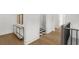 Hallway with wood floors, designer console table, art, and white walls provides a modern, clean aesthetic at 52 25Th Nw St, Atlanta, GA 30309