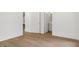 Neutral hallway featuring hardwood floors, neutral paint, and two doors at 52 25Th Nw St, Atlanta, GA 30309