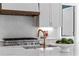 Kitchen features marble countertops, stainless steel appliances, and bronze fixtures at 52 25Th Nw St, Atlanta, GA 30309