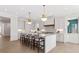 Modern kitchen featuring a large center island with bar stools, stainless appliances, and custom cabinets at 52 25Th Nw St, Atlanta, GA 30309
