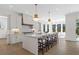 Spacious kitchen featuring a center island with seating, modern lighting, and custom cabinetry at 52 25Th Nw St, Atlanta, GA 30309