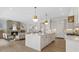 Open kitchen flows to the living room featuring an island with white marble countertops at 52 25Th Nw St, Atlanta, GA 30309