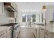 Modern kitchen with stainless steel appliances, marble countertops, and eat-in dining area at 52 25Th Nw St, Atlanta, GA 30309