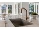 Modern kitchen island with marble countertop, sink, bronze faucet, and stainless steel hardware at 52 25Th Nw St, Atlanta, GA 30309