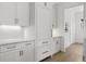 Kitchen includes white cabinets, stainless steel hardware, subway tile backsplash and wood floors at 52 25Th Nw St, Atlanta, GA 30309
