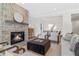 Living room featuring stone fireplace, open view to the dining room, and modern furnishings at 52 25Th Nw St, Atlanta, GA 30309