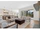 Open-concept living room with hardwood floors, neutral decor, a stone fireplace, and sliding glass doors at 52 25Th Nw St, Atlanta, GA 30309