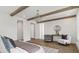 Spacious main bedroom featuring wood beams, stylish seating, and wood floors creating a warm, inviting space at 52 25Th Nw St, Atlanta, GA 30309