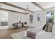 Open main bedroom with wood beams, stylish furniture, and access to an ensuite bathroom creates a luxurious retreat at 52 25Th Nw St, Atlanta, GA 30309