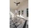 Covered patio featuring brick walls, ceiling fan, and gray tile flooring at 52 25Th Nw St, Atlanta, GA 30309