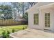 Open patio featuring a brick floor, a brick wall, a French door, and views of the backyard at 52 25Th Nw St, Atlanta, GA 30309