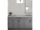 Close-up of a gray vanity in a modern bathroom with marble countertop and decor at 52 25Th Nw St, Atlanta, GA 30309