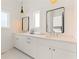 Bright bathroom with double vanity, white cabinets, and black framed mirrors at 10940 Serenbe Ln, Chattahoochee Hills, GA 30268