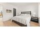 Minimalist bedroom with light hardwood floors, neutral tones, and ample natural light at 10940 Serenbe Ln, Chattahoochee Hills, GA 30268